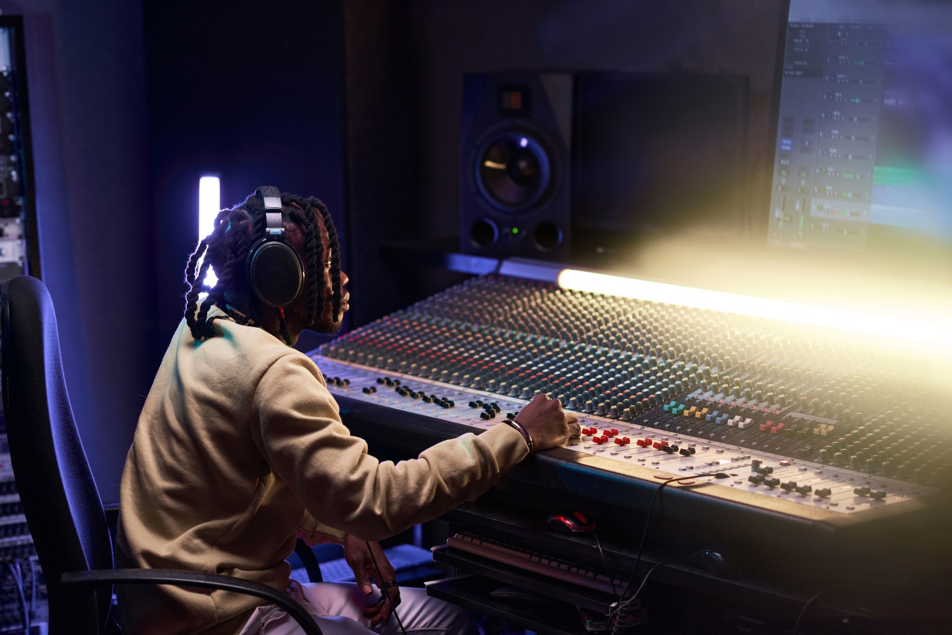 Producer working on music keyboard in the studio
